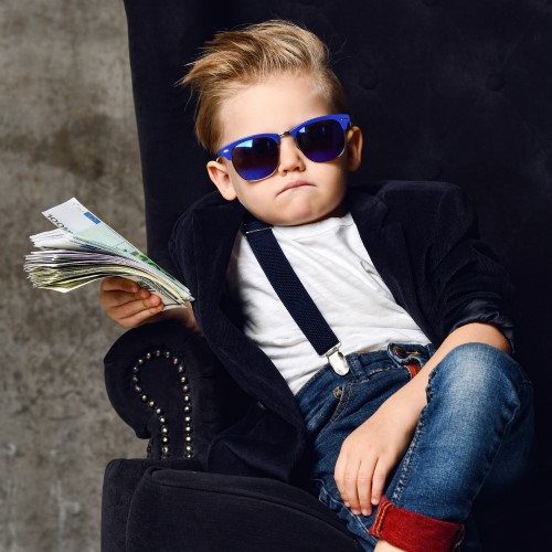 Boy wearing sunglasses holding a wad of cash