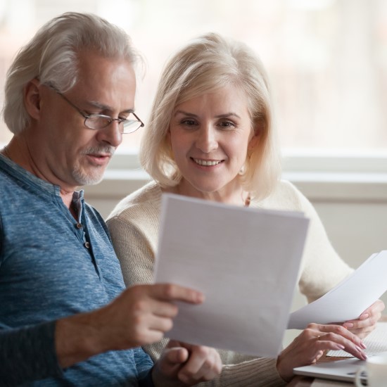 Middle aged couple looking at documents together