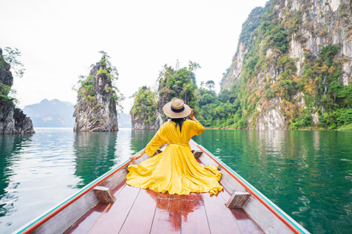 Woman in yellow dress on a boat in Vietnam