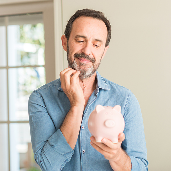 Middle age man save money on piggy bank serious face thinking about question, very confused idea