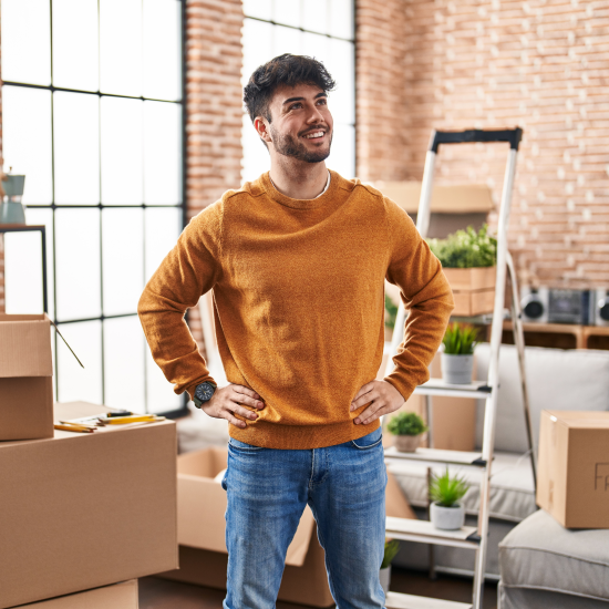 Man looking at his new home surrounded by boxes